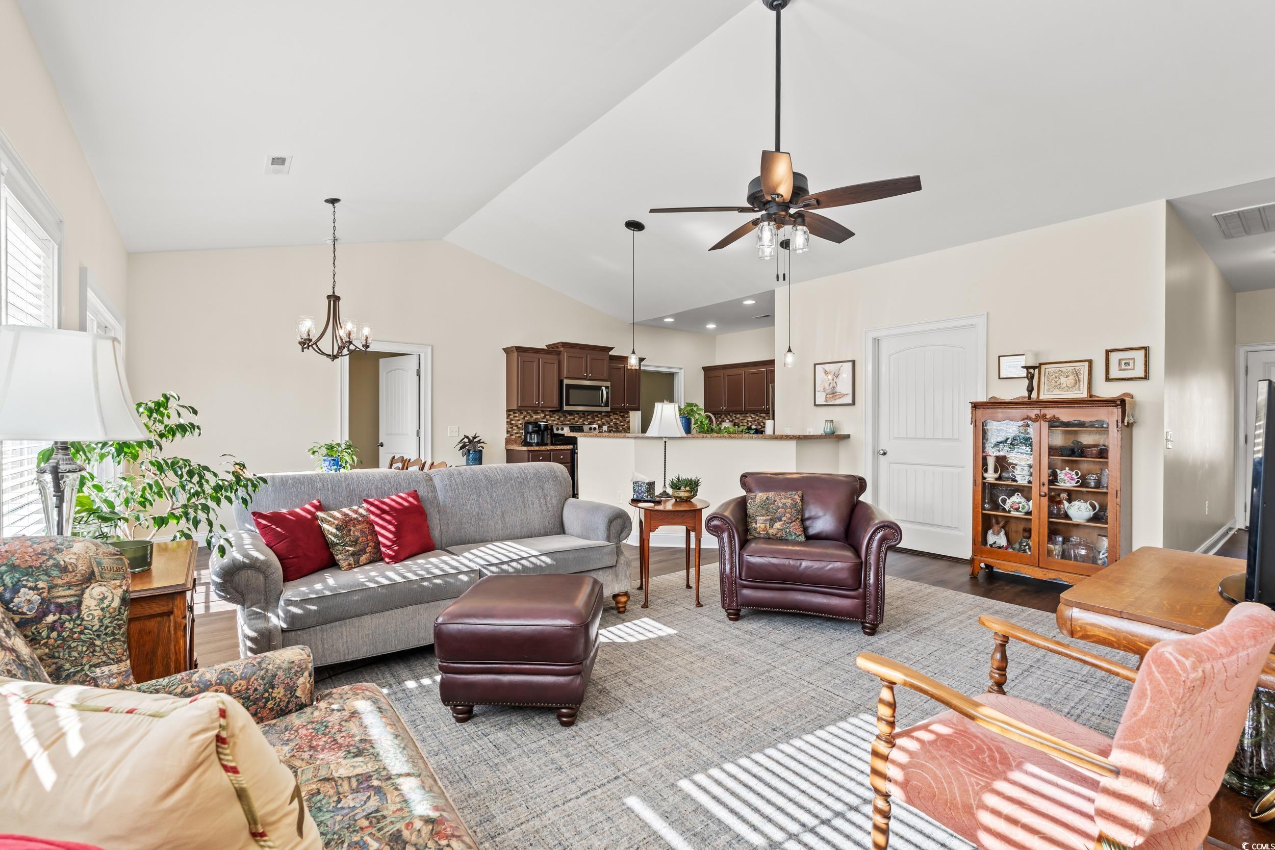 153 Grier Crossing Road Conway, SC 29526 - Photo 4 of 26 Living area featuring lofted ceiling, a chandelier, ceiling fan, and wood finished floors