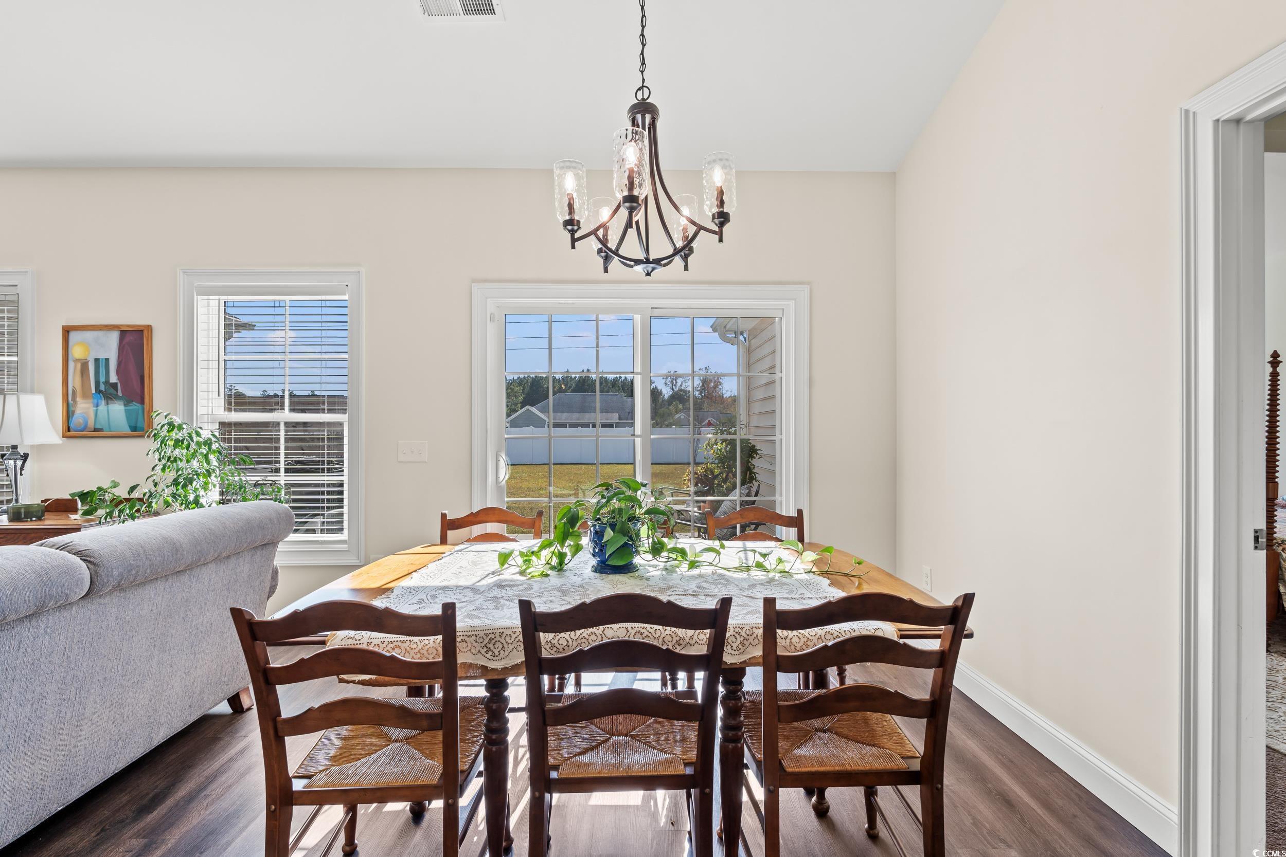153 Grier Crossing Road Conway, SC 29526 - Photo 5 of 26 Dining space featuring healthy amount of natural light, dark wood-type flooring, and a chandelier