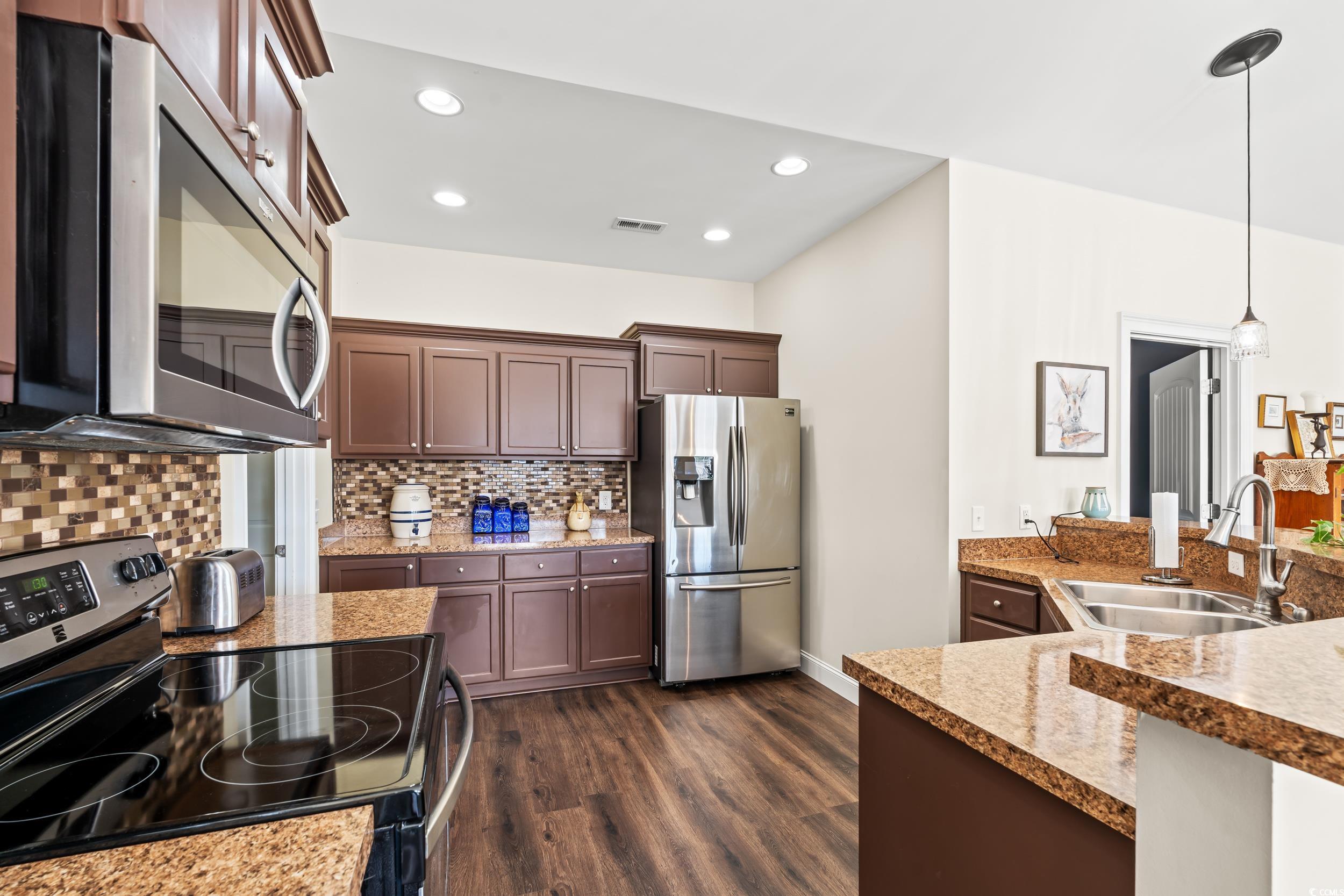 153 Grier Crossing Road Conway, SC 29526 - Photo 6 of 26 Kitchen with stainless steel appliances, decorative light fixtures, dark wood-style floors, decorative backsplash, and recessed lighting