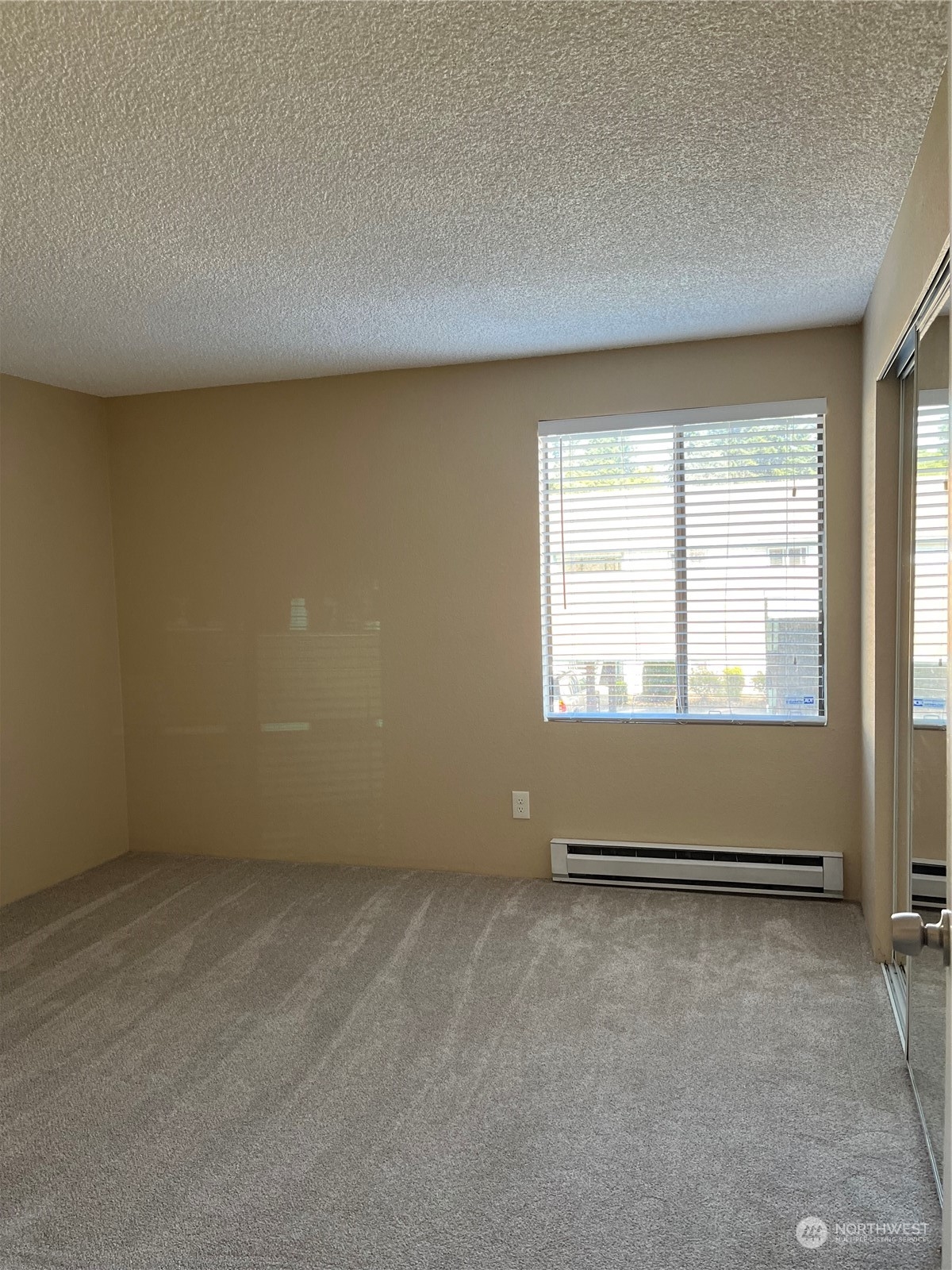 1800 Southwest 318th Place, Unit D Federal Way, WA 98023 - Photo 22 of 22 an empty room with wooden floor and windows