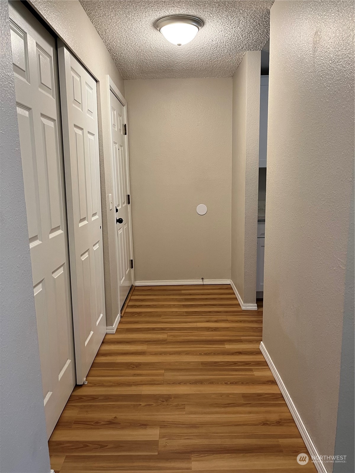 1800 Southwest 318th Place, Unit D Federal Way, WA 98023 - Photo 7 of 22 a view of a hallway with wooden floor and staircase