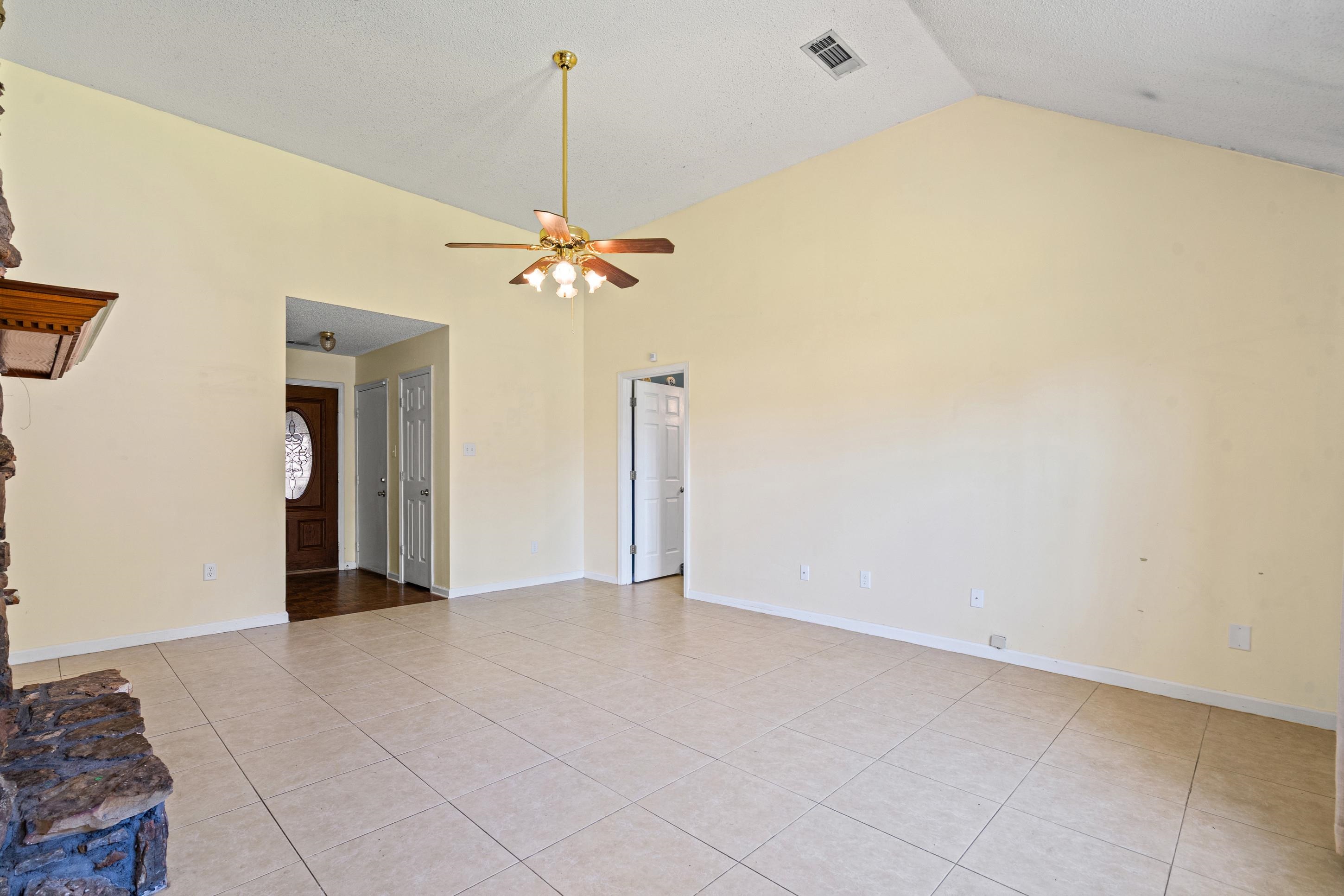 7130 Bryan Station Road Cordova, TN 38018 - Photo 6 of 26 Spacious living area featuring a vaulted ceiling and tile flooring