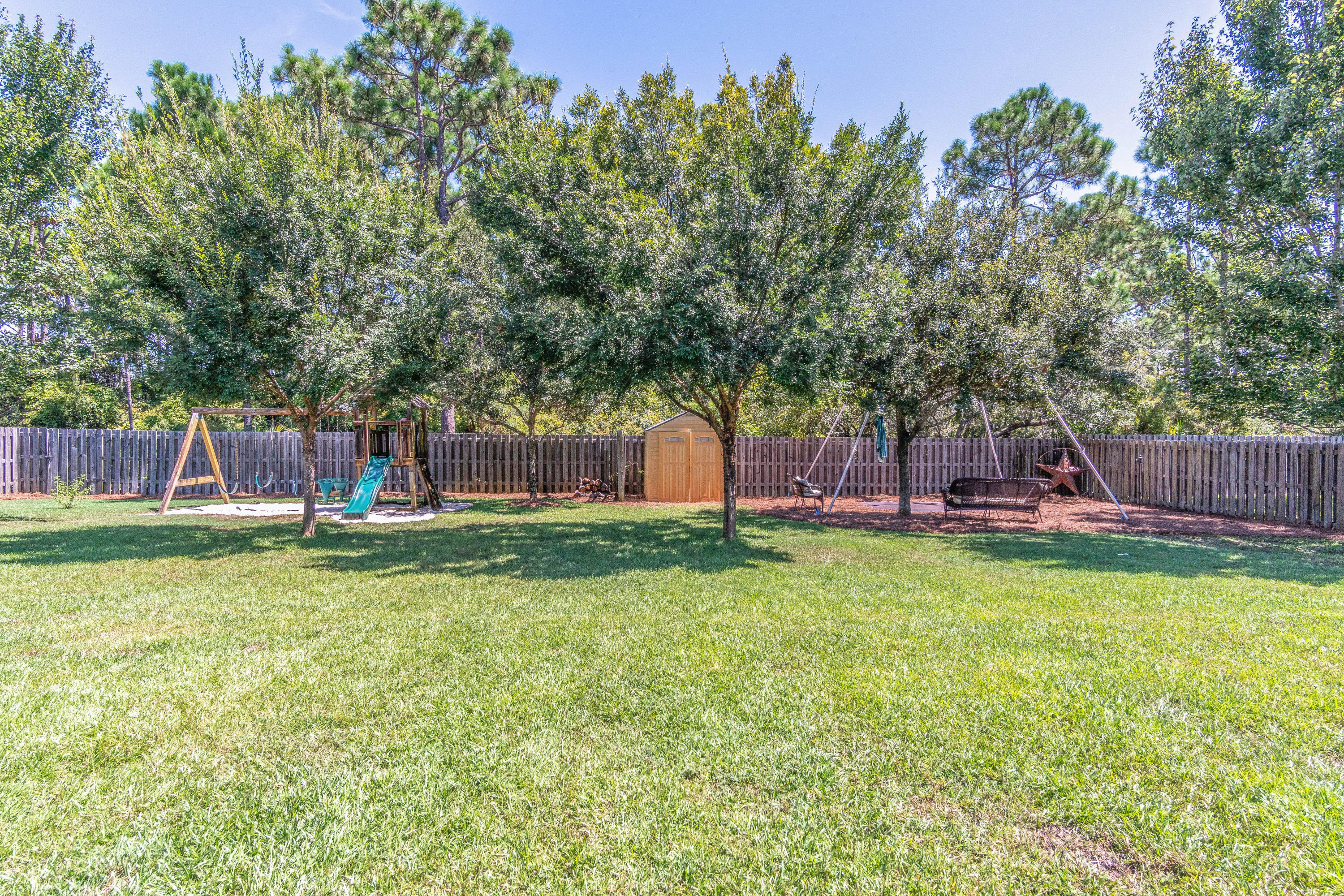 622 East Shipwreck Road Santa Rosa Beach, FL 32459 - Photo 24 of 39 a backyard with large trees and a lots of green space
