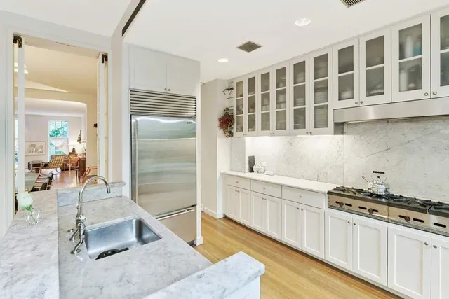 a kitchen with stainless steel appliances granite countertop a stove and a sink