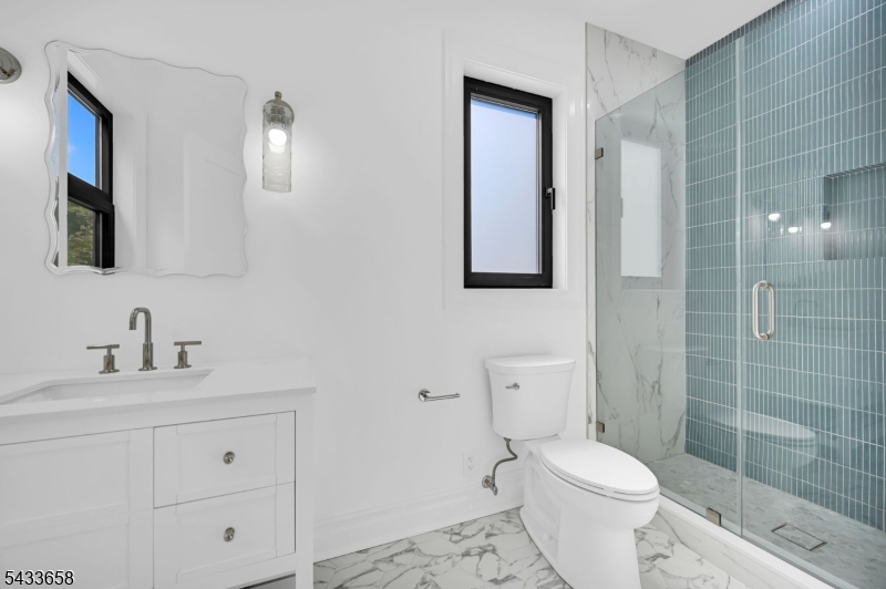 2 Orchard Road Florham Park, NJ 07932 - Photo 18 of 23 a bathroom with a toilet sink vanity and mirror