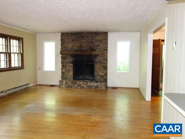 121 Rodes Valley Drive Nellysford, VA 22958 - Photo 5 of 23 a view of an empty room with window and fire place