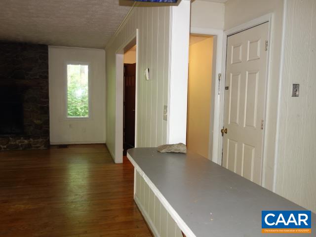 121 Rodes Valley Drive Nellysford, VA 22958 - Photo 7 of 23 an empty room with wooden floor and windows