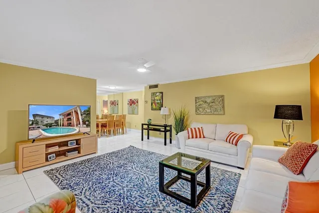 a living room with furniture and a floor to ceiling window