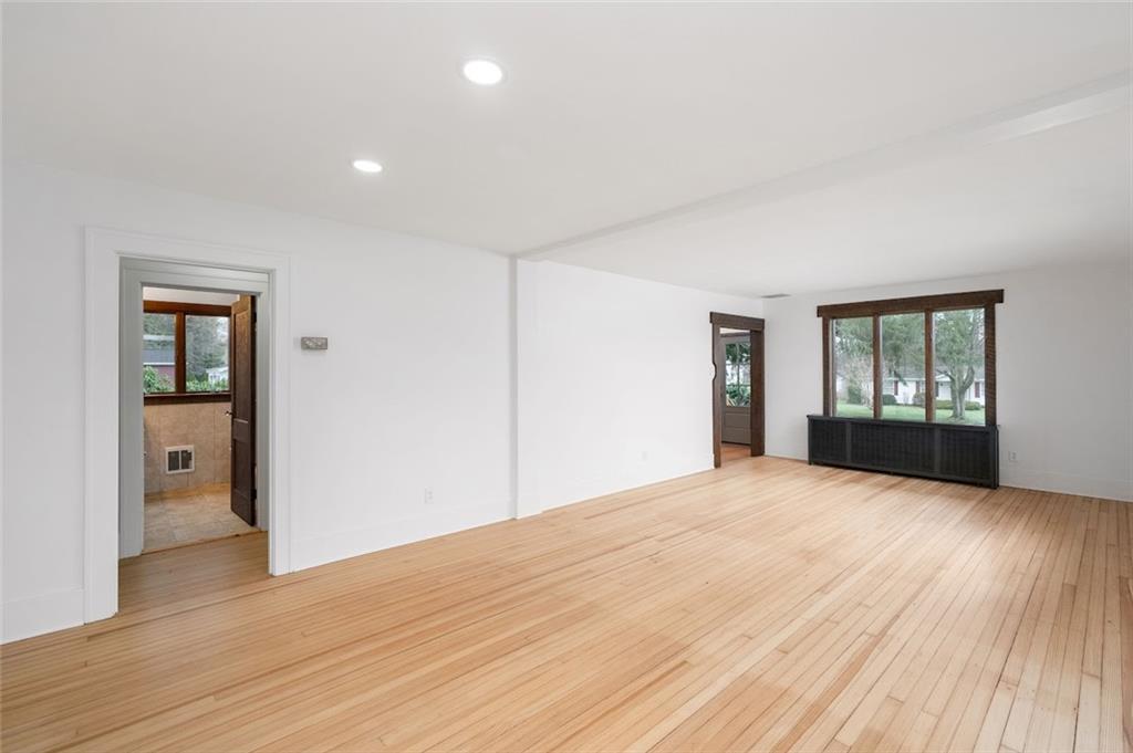 108 Buttercup Road Butler, PA 16001 - Photo 17 of 40 a view of an empty room with wooden floor and a window