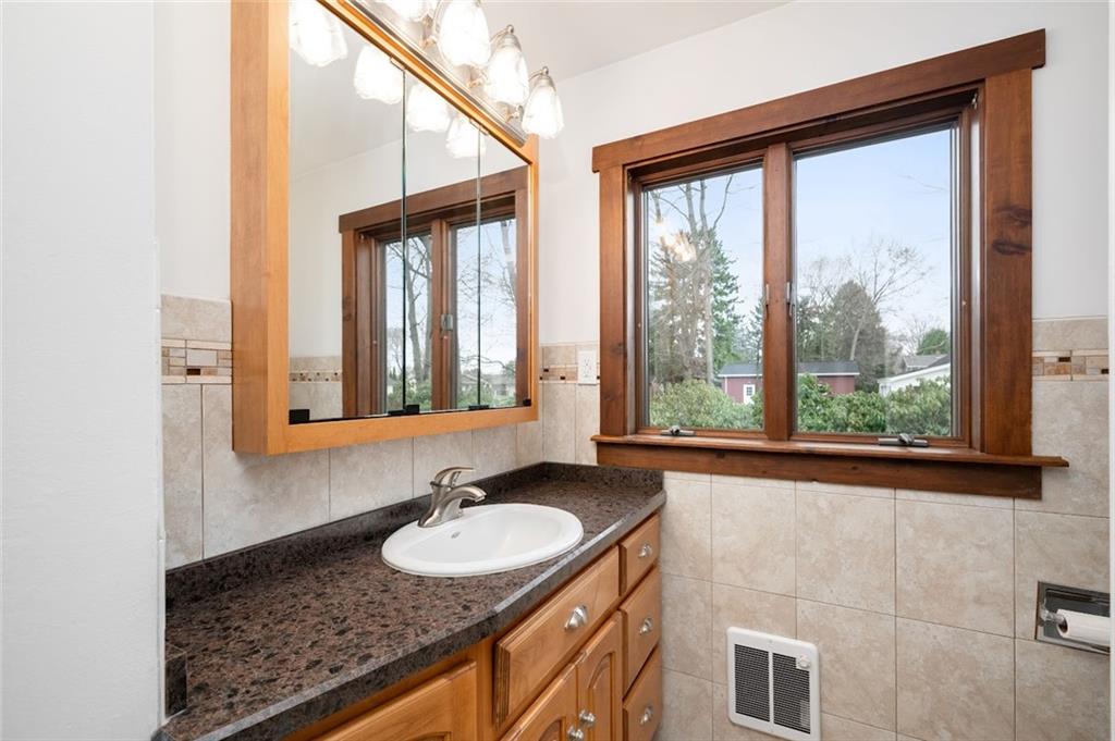 108 Buttercup Road Butler, PA 16001 - Photo 30 of 40 a bathroom with a granite countertop sink and a large mirror