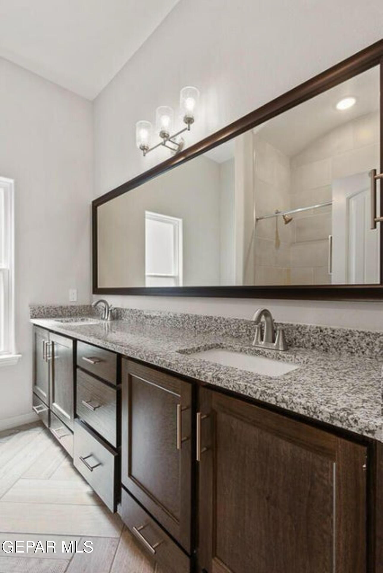 6046 Summer Ridge Sunland Park, NM 88008 - Photo 8 of 11 a bathroom with a granite countertop sink a large mirror and a toilet