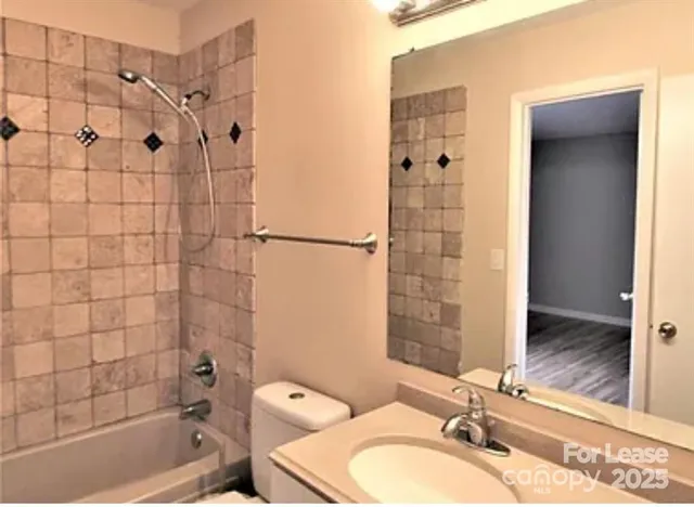 a bathroom with a sink shower and a mirror