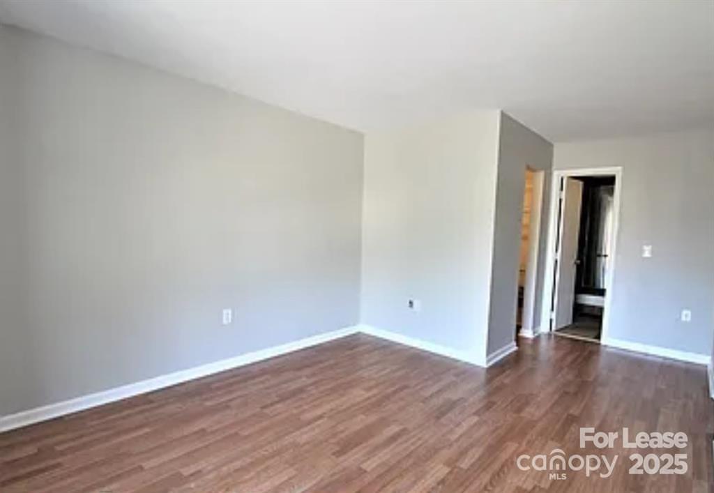 4809 Spring Lake Drive, Unit E Charlotte, NC 28212 - Photo 13 of 18 a view of an empty room with wooden floor