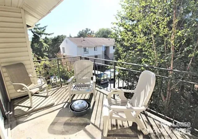 a view of a chairs and table in the balcony