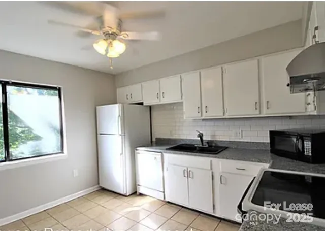 a kitchen with a refrigerator and a sink