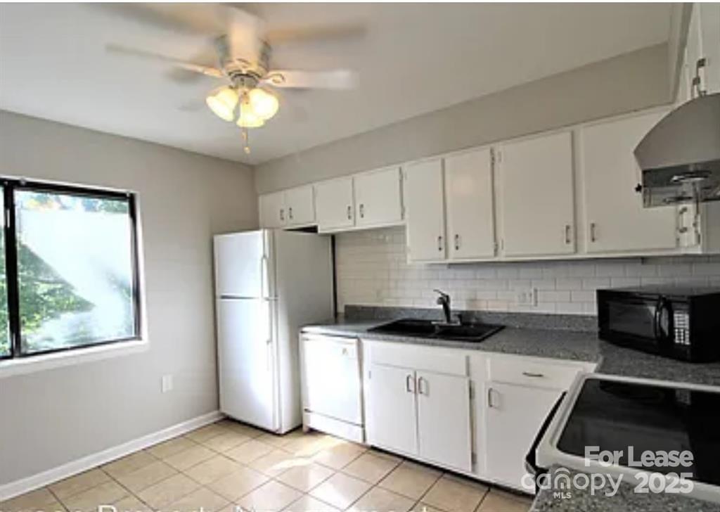 4809 Spring Lake Drive, Unit E Charlotte, NC 28212 - Photo 4 of 18 a kitchen with a refrigerator and a sink