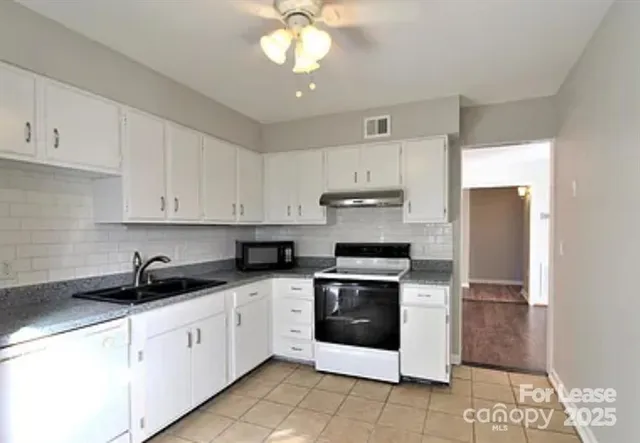 a kitchen with cabinets stainless steel appliances and a sink
