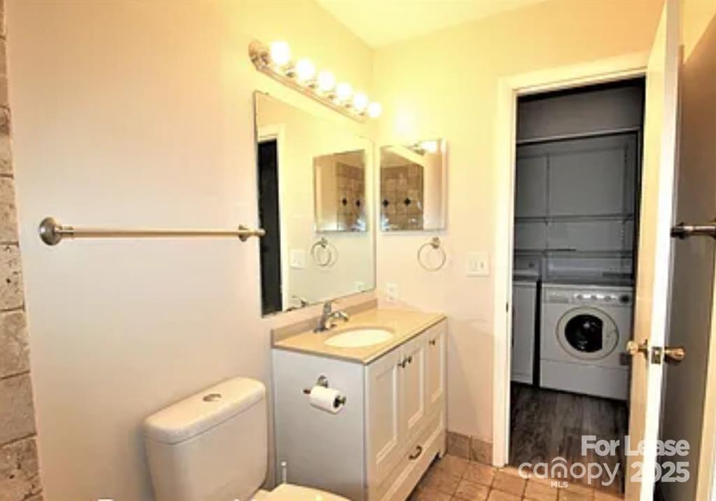 4809 Spring Lake Drive, Unit E Charlotte, NC 28212 - Photo 9 of 18 a bathroom with a sink a toilet and shower