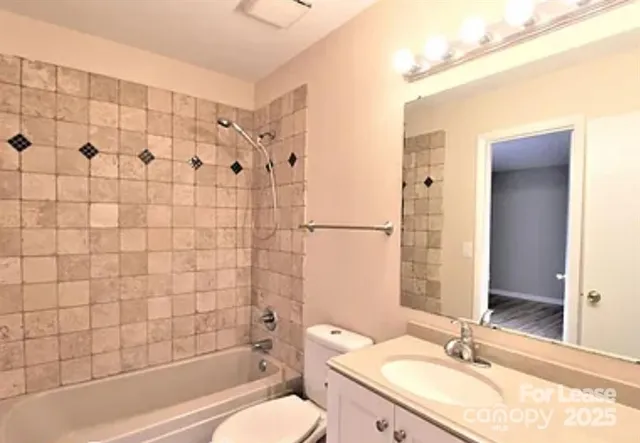 a bathroom with a granite countertop sink toilet a shower and a mirror
