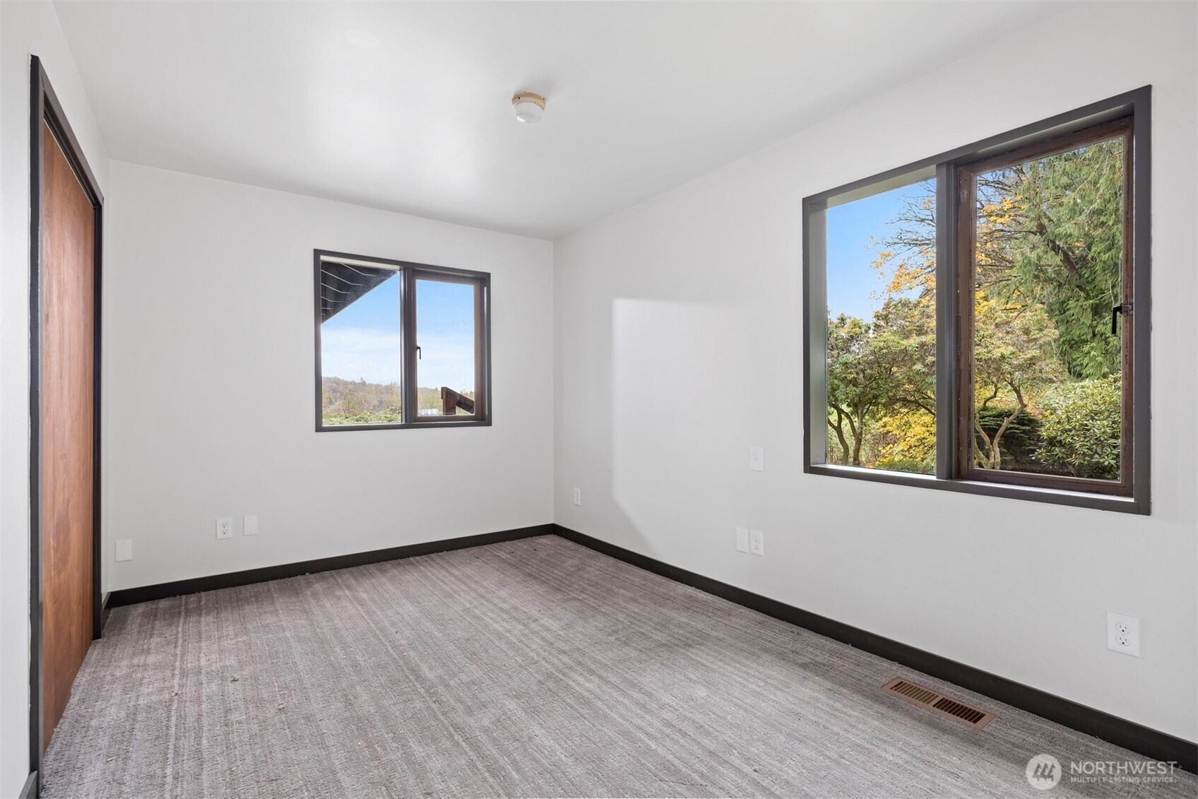 18928 Bow Hill Road Burlington, WA 98233 - Photo 17 of 39 a view of an empty room with wooden floor and a window