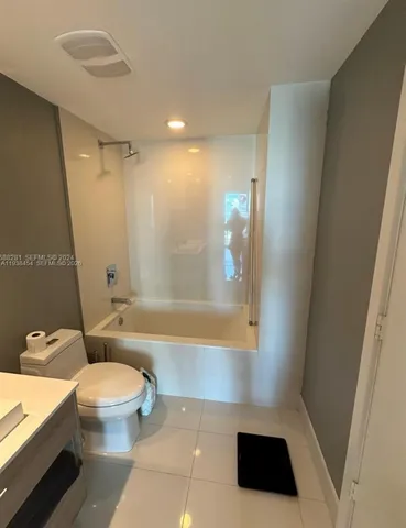 a bathroom with a bathtub a toilet a sink and a shower