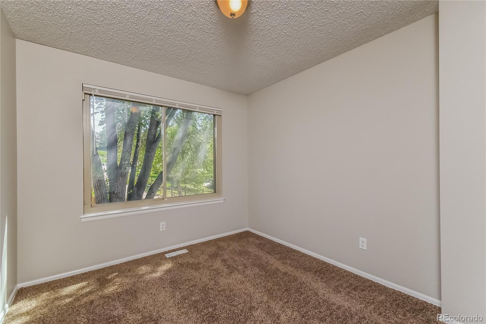 5245 Quasar Court Colorado Springs, CO 80917 - Photo 13 of 18 an empty room with windows and air conditioner
