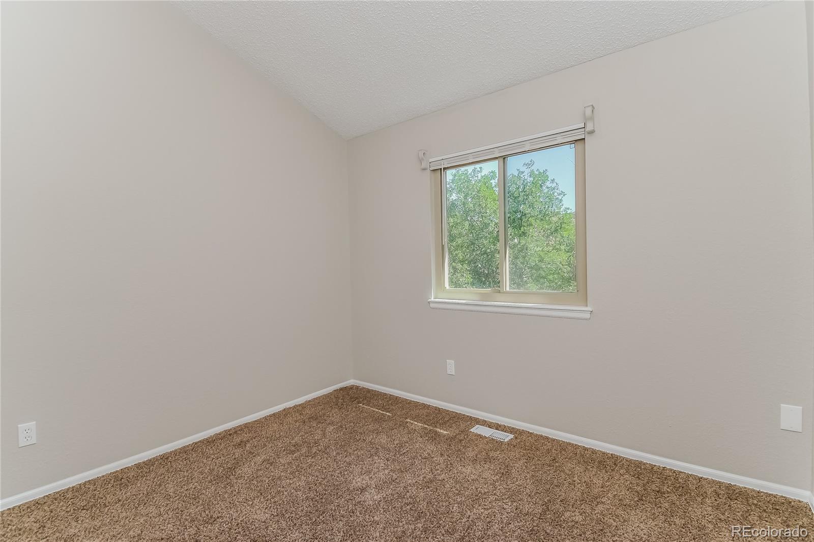 5245 Quasar Court Colorado Springs, CO 80917 - Photo 8 of 18 an empty room with a window