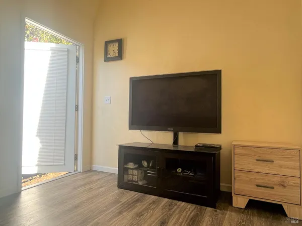 a living room with furniture and flat screen tv