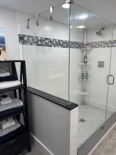 a bathroom with a shower and a sink