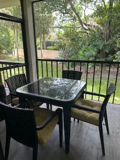 a view of a balcony with table and chairs
