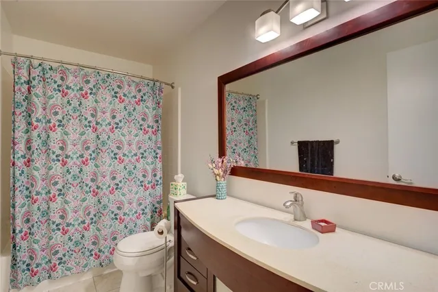 a bathroom with a sink toilet and a mirror
