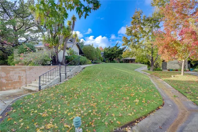 a view of a garden with a house