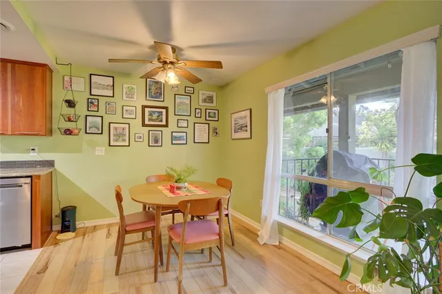 a dining room with furniture a rug and a potted plant