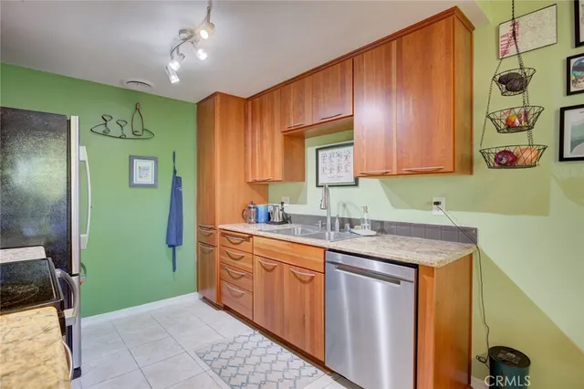 a kitchen with stainless steel appliances granite countertop a sink and cabinets