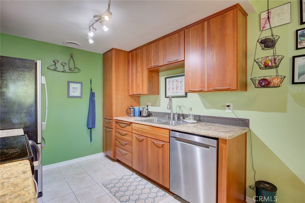 1750 Prefumo Canyon Road, Unit 48 San Luis Obispo, CA 93405 - Photo 10 of 32 a kitchen with stainless steel appliances granite countertop a sink and cabinets