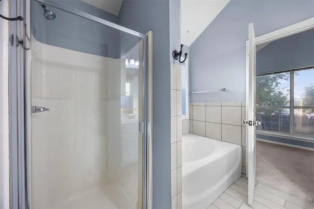 a bathroom with a bathtub and shower