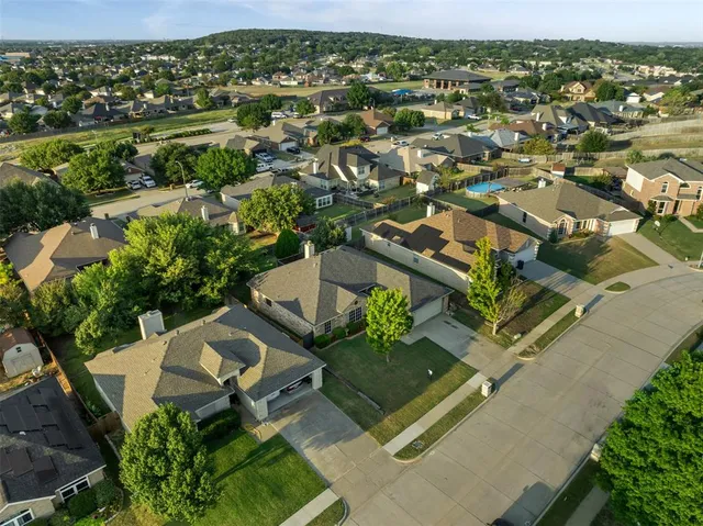 an aerial view of residential houses with outdoor space