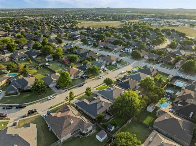 an aerial view of residential houses with outdoor space