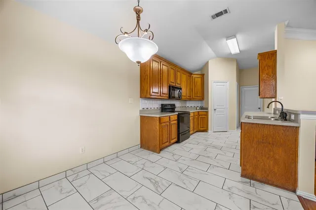a kitchen with stainless steel appliances a sink and a refrigerator