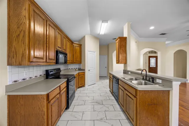 a kitchen with stainless steel appliances granite countertop a sink stove and cabinets