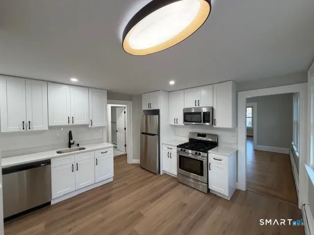 a kitchen with granite countertop a sink and cabinets