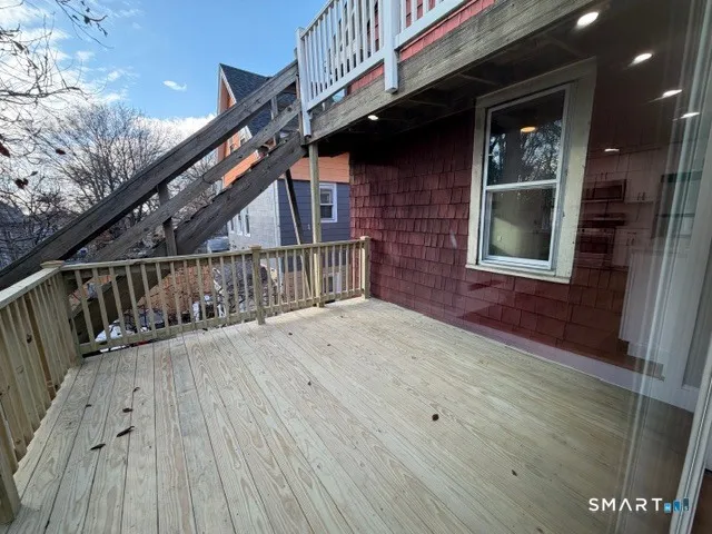 a view of balcony with wooden floor and stairs