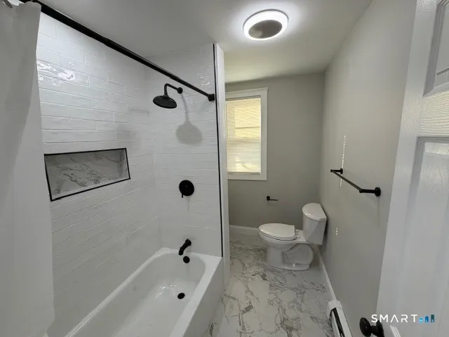 a bathroom with a toilet sink and shower