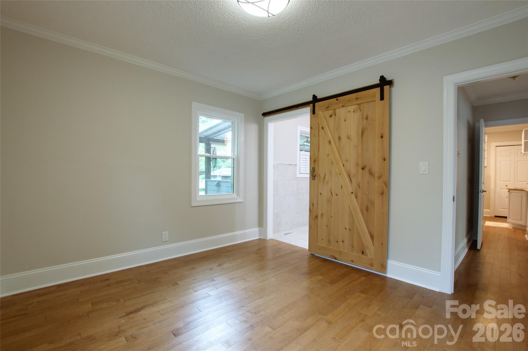 204 Clinton Avenue Clover, SC 29710 - Photo 10 of 26 an empty room with wooden floor and windows
