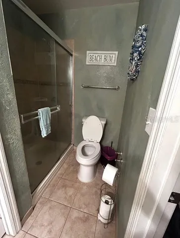 a bathroom with a toilet and a mirror