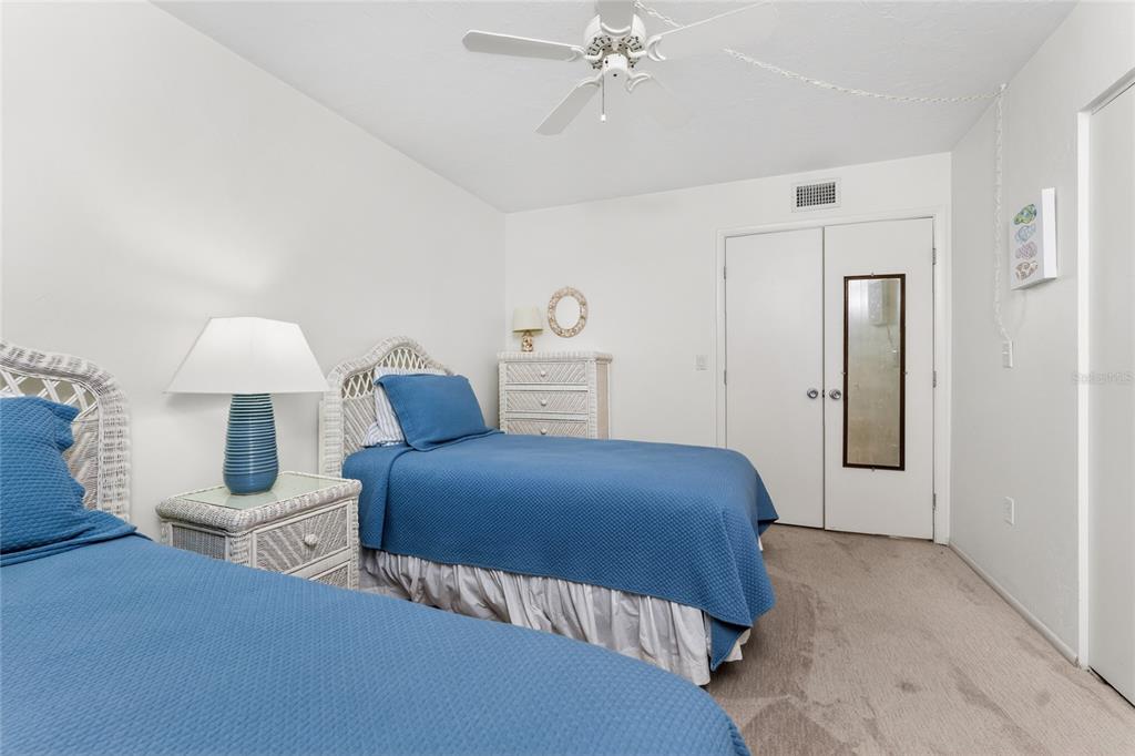 2955 North Beach Road, Unit B614 Englewood, FL 34223 - Photo 31 of 67 a bedroom with a bed and a lamp