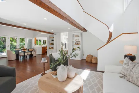 a kitchen with a stove a sink a dining table and chairs