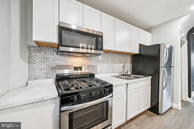 a kitchen with a stove microwave and refrigerator