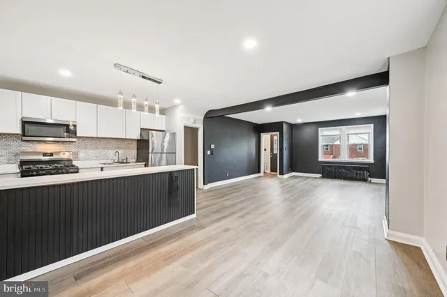 a kitchen with stainless steel appliances granite countertop a stove and cabinets