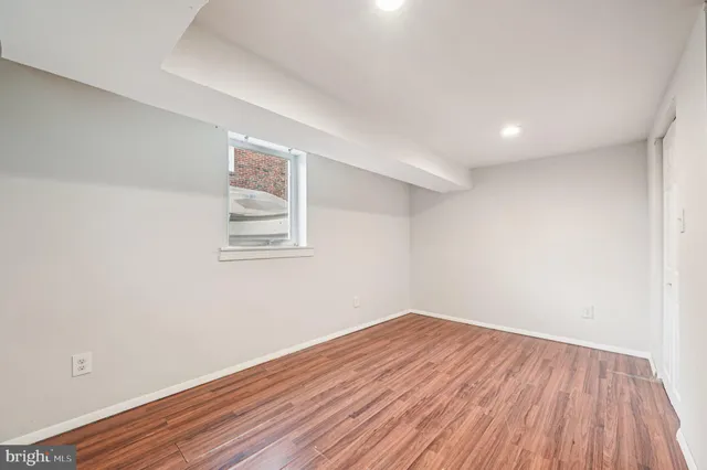 a view of a room with wooden floor and white walls